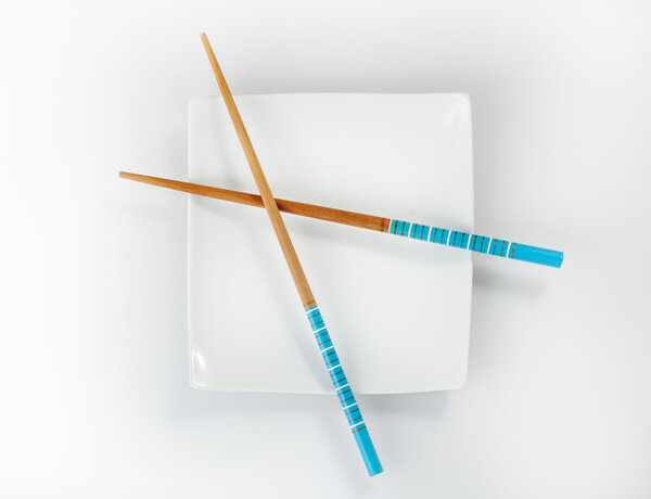 Chopsticks on a white plate