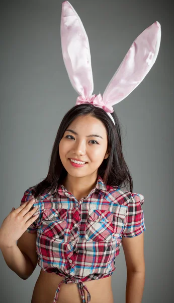 Portrait of sexy asian cowgirl wearing easter's bunny ears — Stock Photo, Image