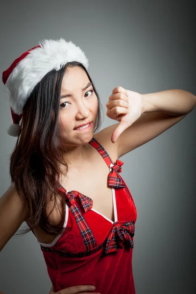 Seksi Asyalı Noel Baba ile bir başparmak gri backgroound üzerinde — Stok fotoğraf