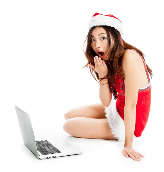 Sexy asian santa claus sitting with laptop and astonished — Stock Photo, Image