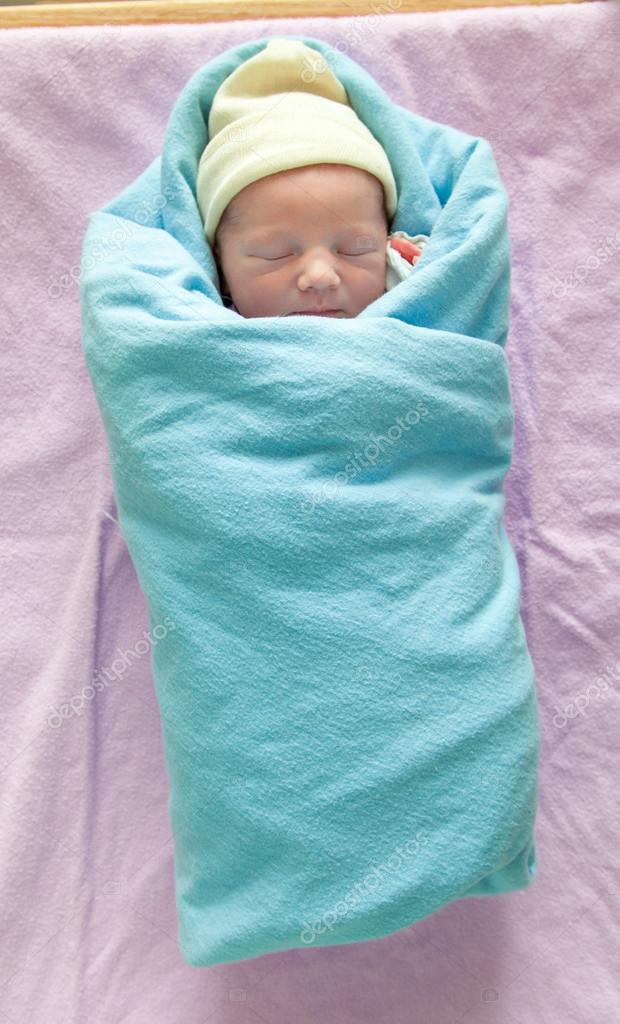 baby in swaddling clothes