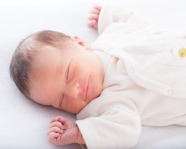 Infant sleeping in bed clipart