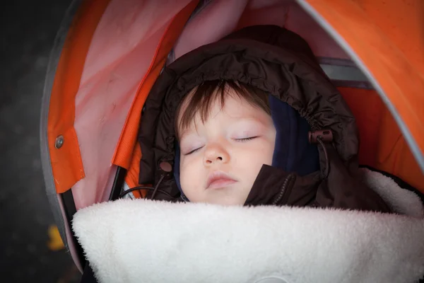 Sleeping boy in pram — Stock Photo, Image