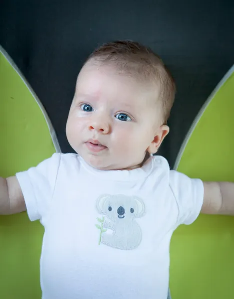 Baby lying down on a carpet — Stock Photo, Image