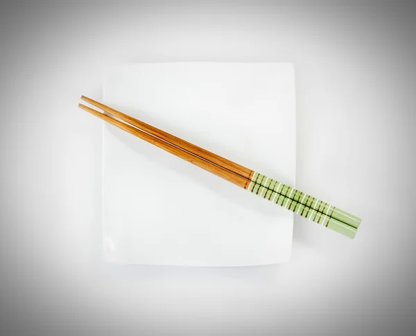 Chopsticks on a plate — Stock Photo, Image