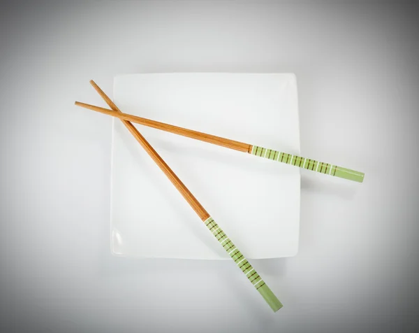 Chopsticks on a plate — Stock Photo, Image