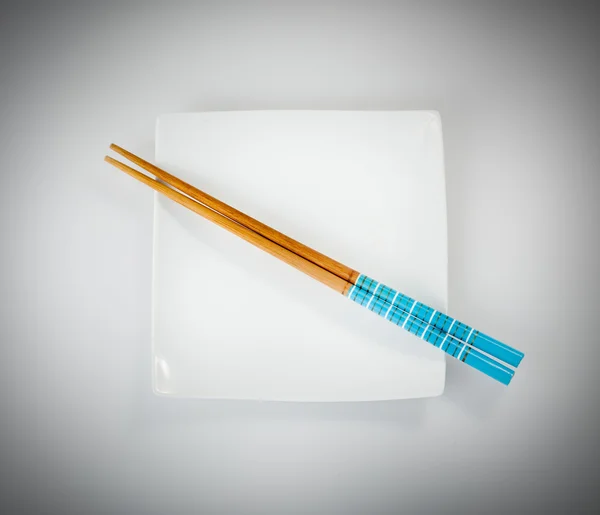 Wooden chopsticks in bowl — Stock Photo, Image