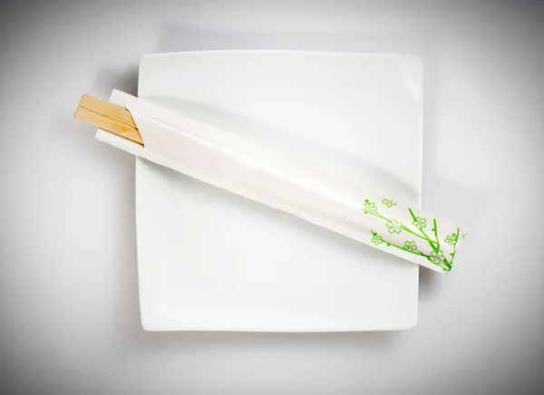 Chopsticks em tigela quadrada — Fotografia de Stock