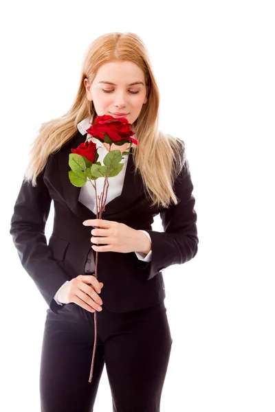 Podnikatelka vonící růže květ — Stock fotografie