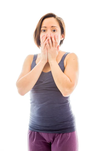 Woman with hand over mouth — Stockfoto