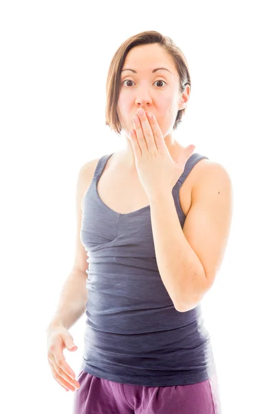 Woman with hand over mouth — Stockfoto