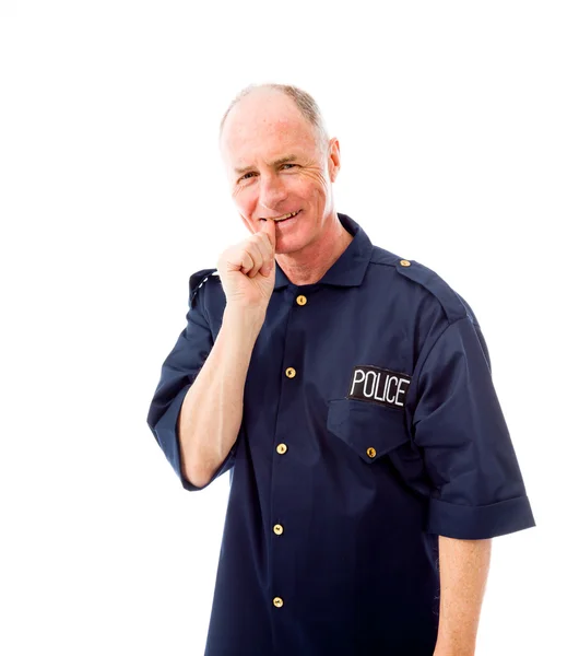 Politieagent met vinger in mond — Stockfoto