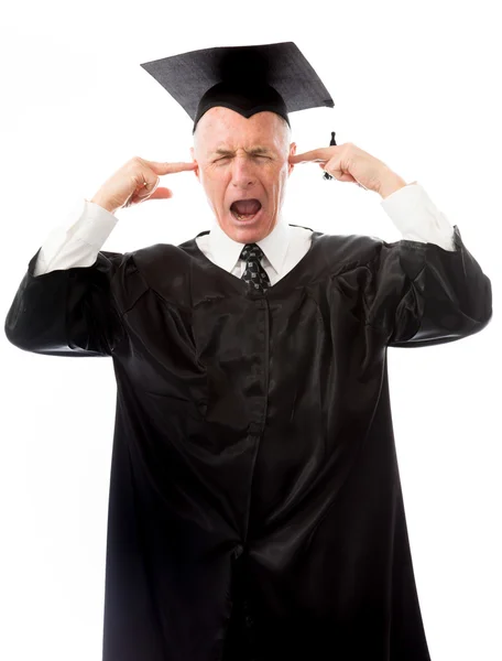 Graduate crying with fingers in ears — Stock Photo, Image