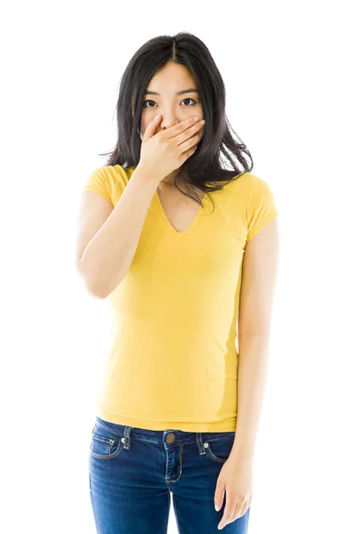 Woman with hand over mouth — Stockfoto