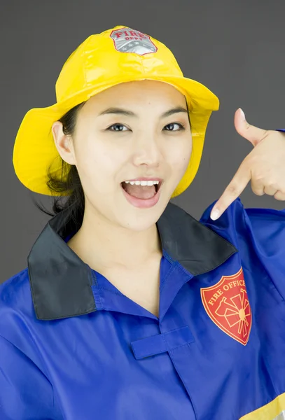 Firefighter pointing at herself — Stock Photo, Image