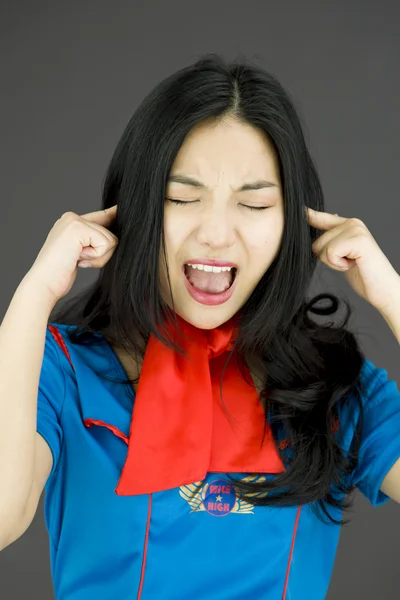 Stewardess with hands in ears — Stock Photo, Image