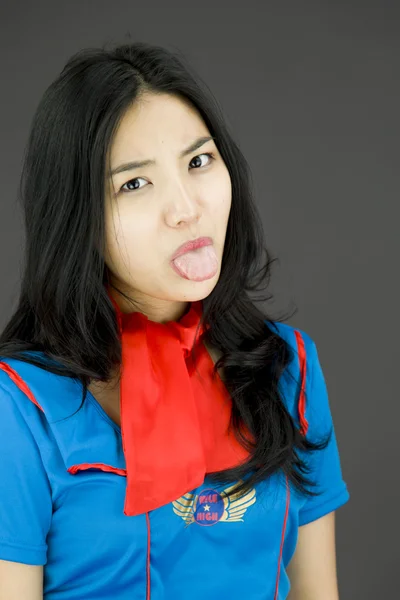 Stewardess poking out tongue — Stock Photo, Image