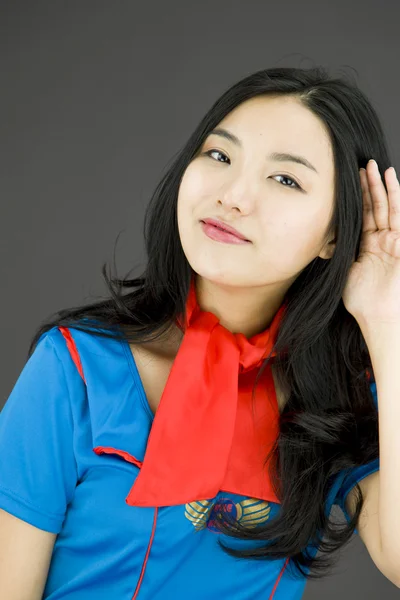 Air stewardess listening with hand to ear — Stock Photo, Image