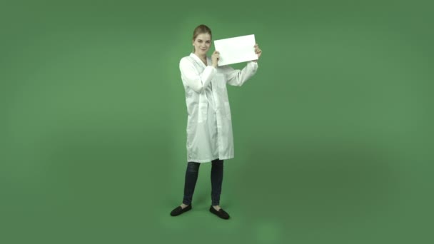 Happy girl in lab coat with blank sign — Stock Video