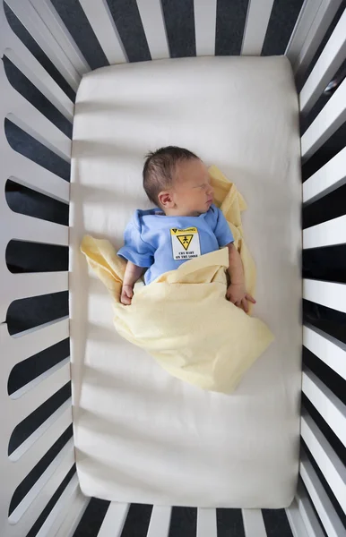 Newborn baby sleeping in a crib — Stock Photo, Image