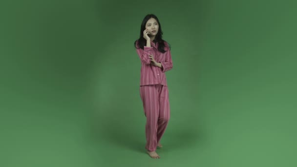 Woman in pajamas talking on cell phone — Stock Video