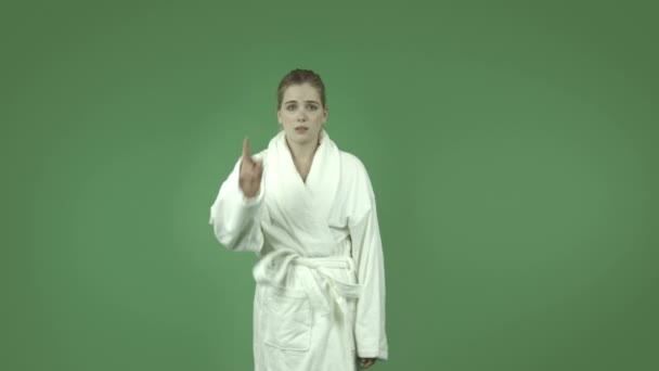 Girl in bathrobe with fingers crossed — Stock Video