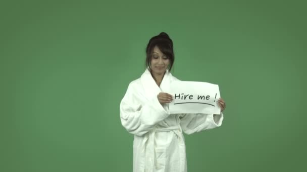 Woman in bathrobe with hire me sign — Stock Video