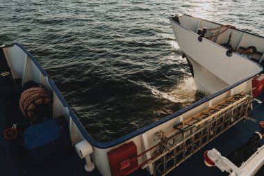  Front part of touristic catamaran boat sailing trough the baltic sea during the sunset