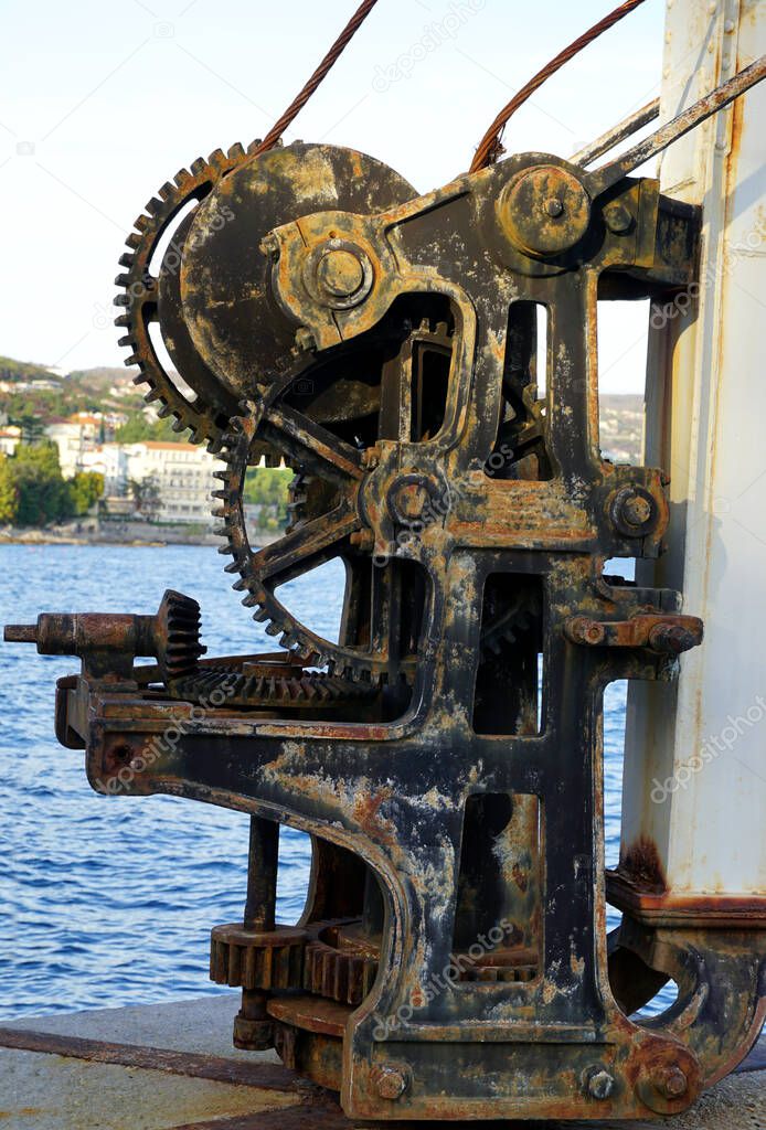 Vintage rusty mechanism of an old steel crane for ships