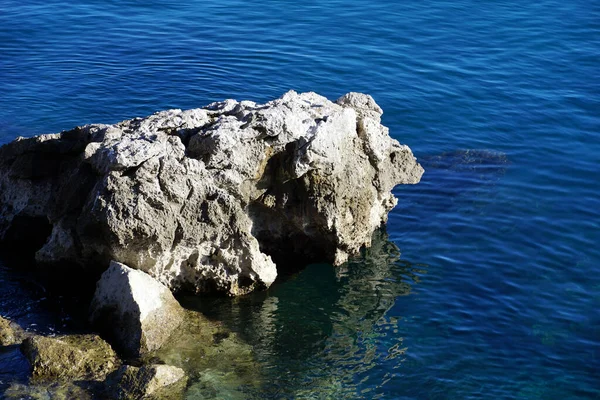 Large Limestone Rock Sea Its Reflection Seawater — стоковое фото