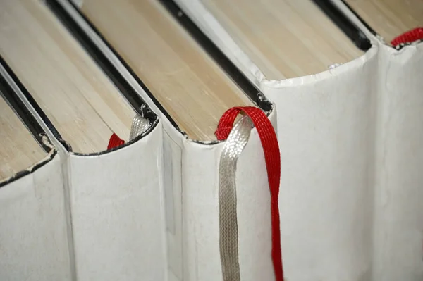 White books with a white cover from which a textile bookmark emerges