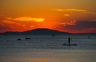 Scenic conceptual background of summer vacation with an aerial view of the sea during sunset