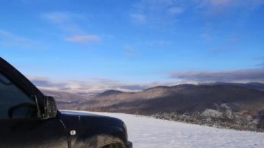 Time laps of a winter landscape with SUV in the Carpathian mountains 