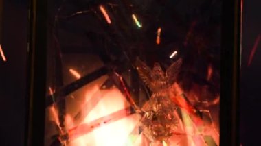 Angel behind a broken window by military action