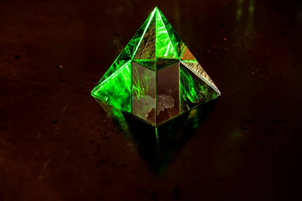 Crystal pyramid in the rays for background