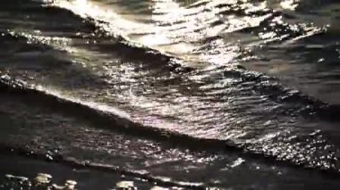 The surf of the lake at golden hour