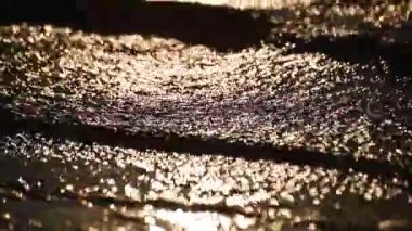 The surf of the lake at golden hour