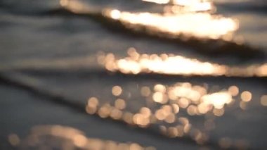 The surf of the lake at golden hour