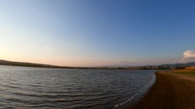 The surf of the lake at golden hour
