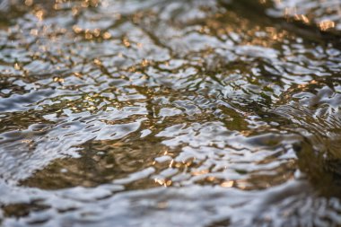Texture pattern of light on the waves of a mountain river
