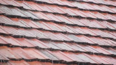 Strong summer thunderstorm on a tile roof