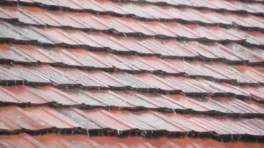 Strong summer thunderstorm on a tile roof