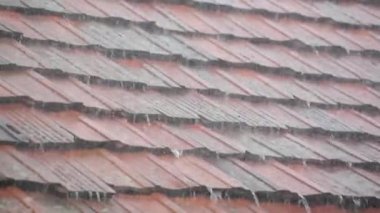 Strong summer thunderstorm on a tile roof