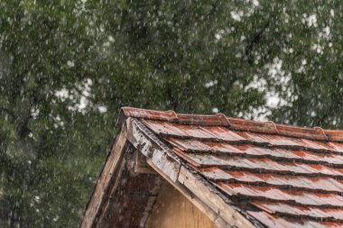 Strong summer thunderstorm on a tile roof