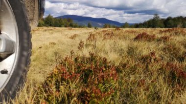 Autumn landscape in the Carpathian countryside with SUV