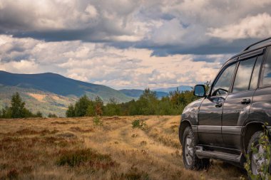 Autumn landscape in the Carpathian countryside with SUV