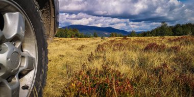 Autumn landscape in the Carpathian countryside with SUV