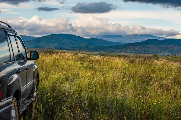 stock image Autumn landscape of the Carpathian countryside with SUV