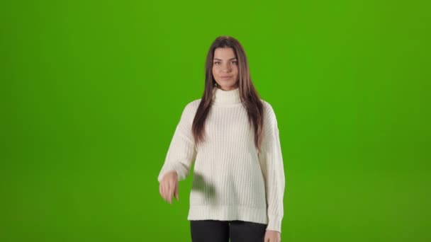 Woman clicking twice with index finger over green background — Stockvideo