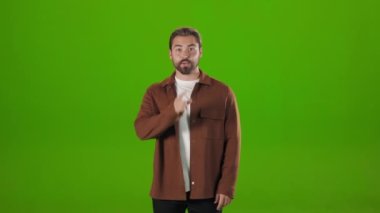 Man holding finger near mouth and asking for silence